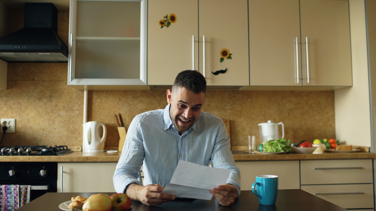 A person reviewing estate documents at a kitchen table at home